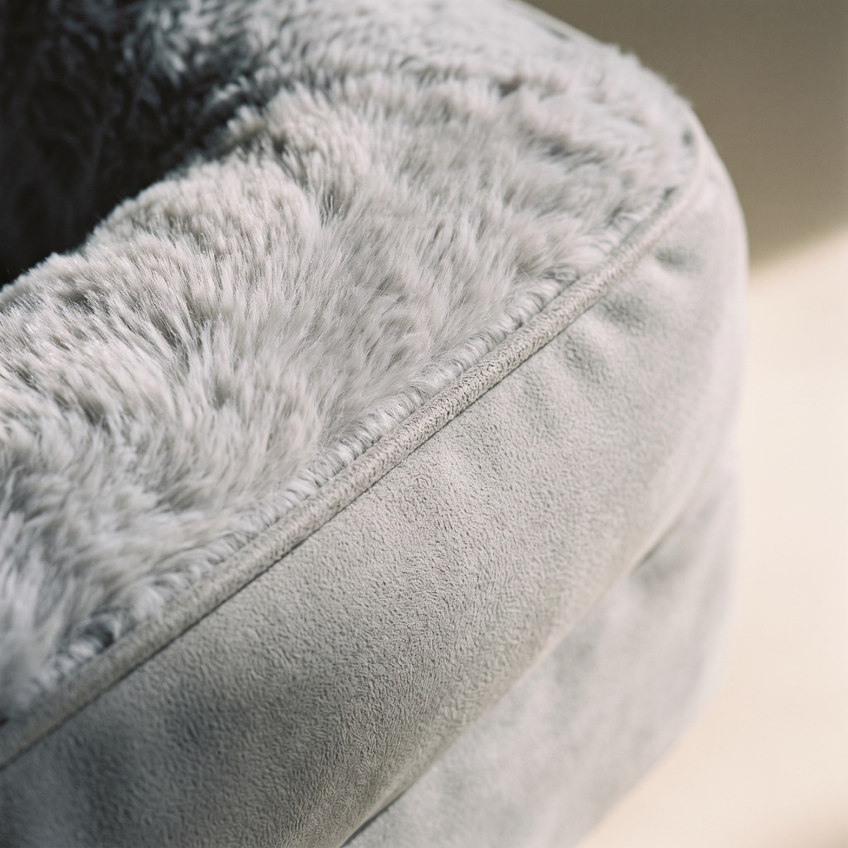 Close up of the piped welt where the microsuede outer meets the long pile fur
