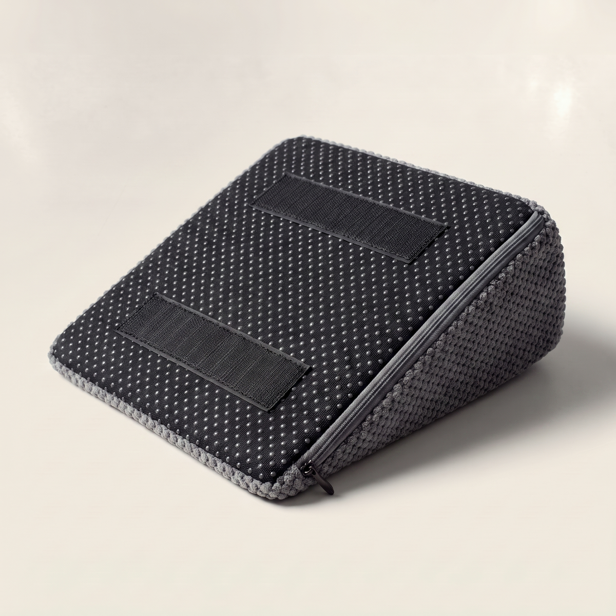 The underside of the Doxie Guard stair wedge showing the anti slip dotted base and two hook tape patches